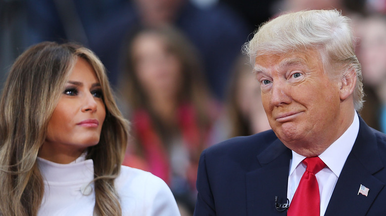 Melania Trump regards husband Donald Trump as he makes a face