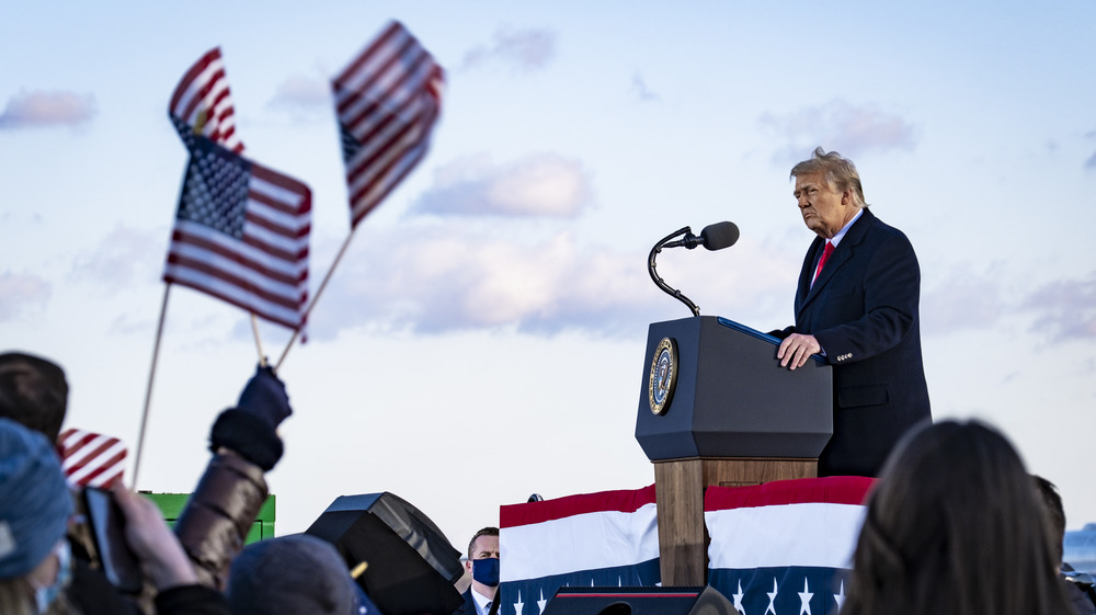 Trump standing at president's podium