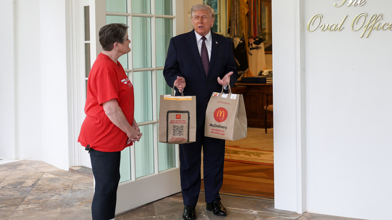 Donald Trump holding McDonald's bags with Sharon Simmons, the "Doordash Grandma," outside the Oval Office