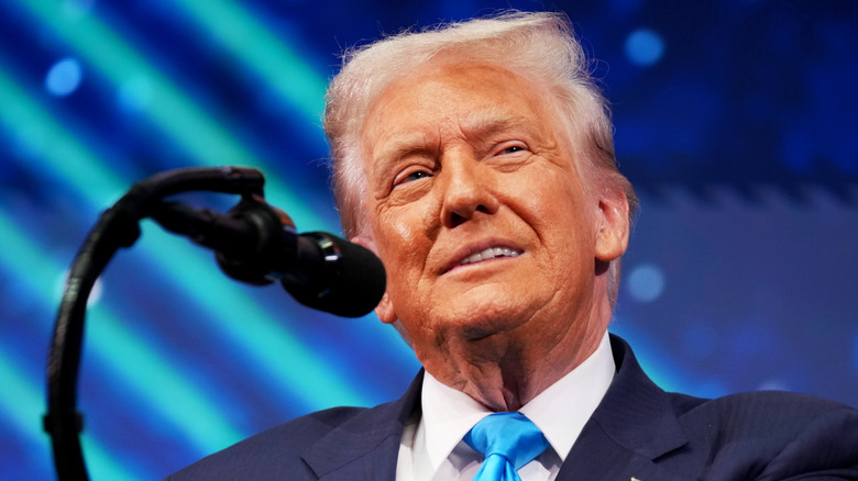 Donald Trump grinning at a podium