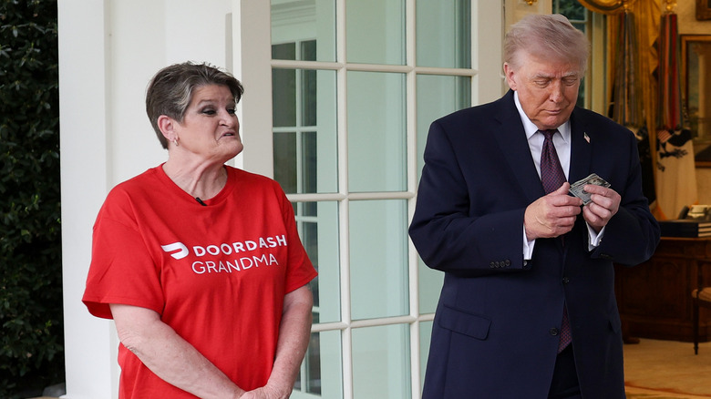 President Donald Trump tips Sharon Simmons after receiving a DoorDash delivery of McDonald's during an event outside the Oval Office of the White House on April 13, 2026 in Washington, DC.