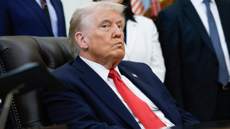 Donald Trump pouting from behind his desk