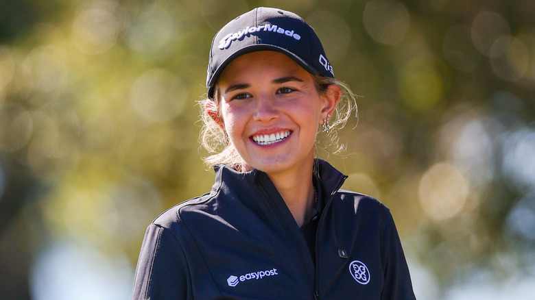 Kai Trump smiles on the golf course