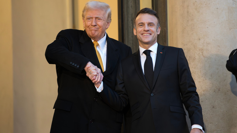 Donald Trump awkwardly shaking the hand of French President Emmanuel Macron