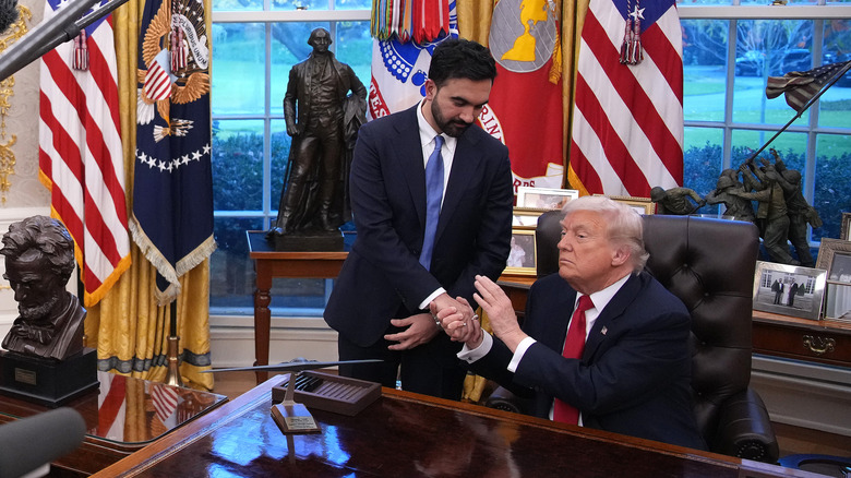 Donald Trump holding and patting Zohran Mamdani's hand in the Oval Office