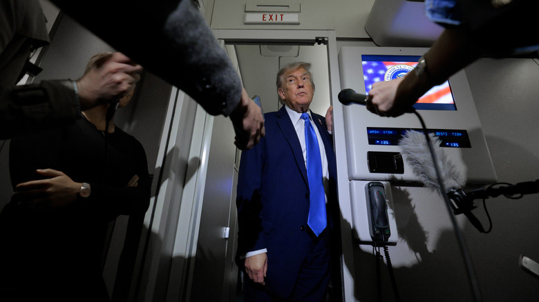 Donald Trump answering questions from reporters on Air Force One