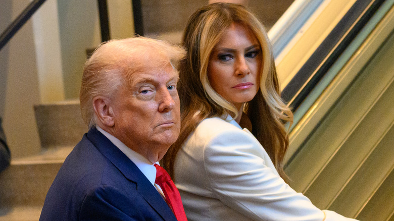 Melania Trump side-eyeing Donald Trump while trying to ride an escalator