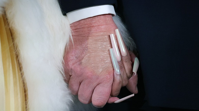 Closeup of Donald Trump and Nicki Minaj holding hands