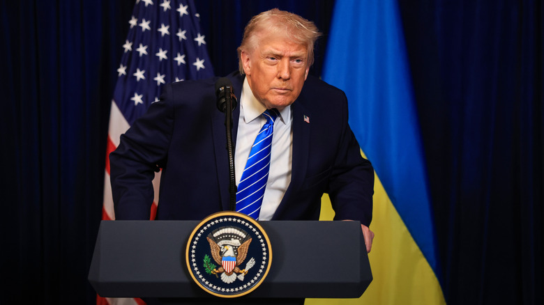 Donald Trump leaning over a podium to stare somebody down