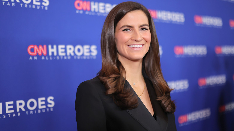 Kaitlan Collins smiling on the red carpet in a black blazer