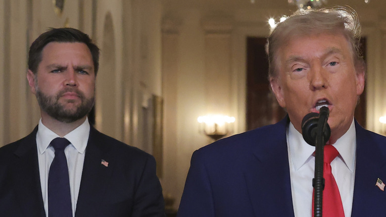 JD Vance standing behind Donald Trump
