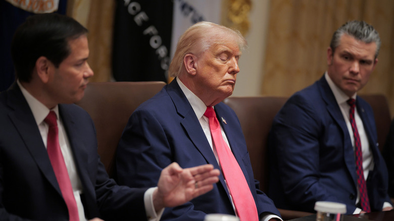 Secretary of State Marco Rubio (L) speaks as U.S. President Donald Trump and U.S. Secretary of War Pete Hegseth look on during a Cabinet meeting in the Cabinet Room of the White House on December 02, 2025.