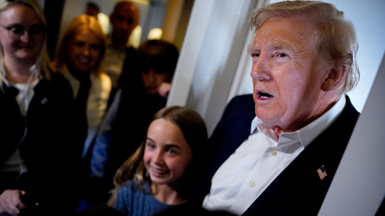 Chloe Trump poses with grandfather Donald Trump
