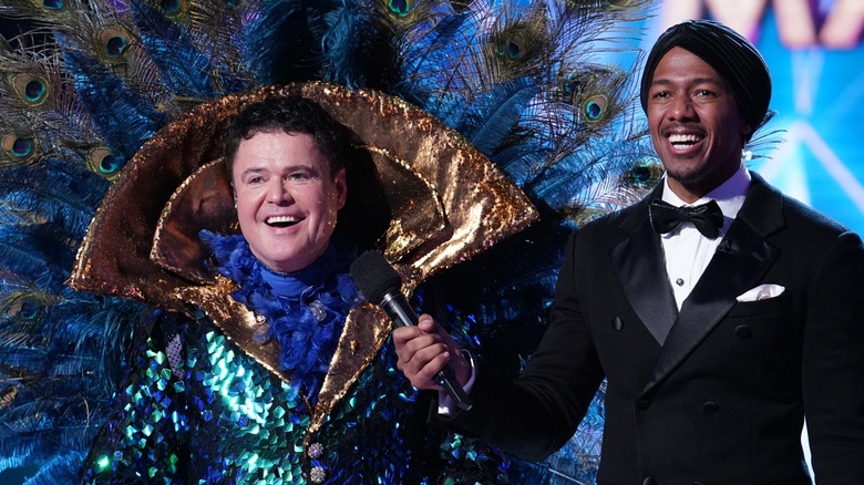 Nick Cannon with an unmasked Donny Osmond on 'The Masked Singer'