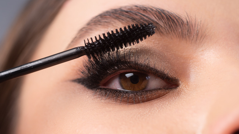 woman applying mascara