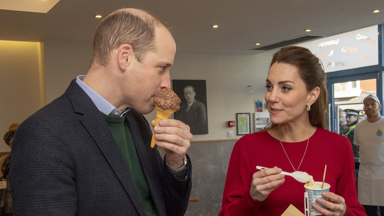 Prince William takes a bite of an ice cream cone 