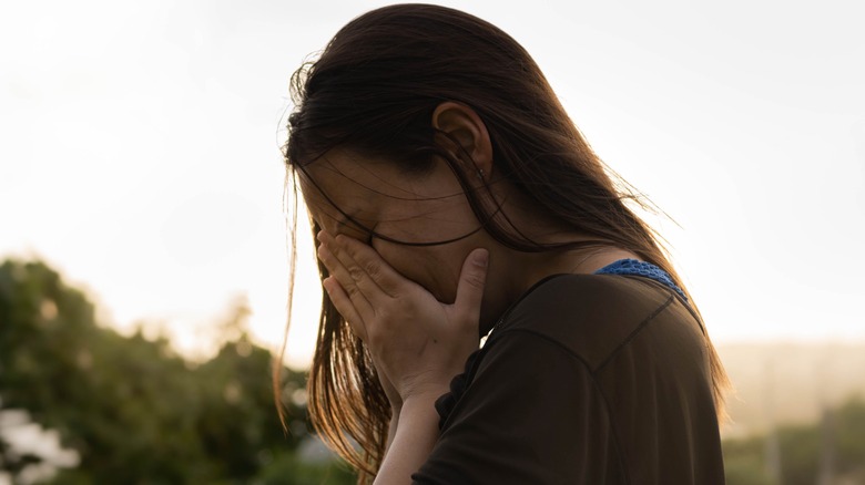 stressed woman standing outside