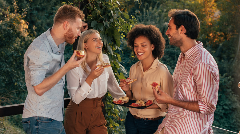 two couples eating pizza