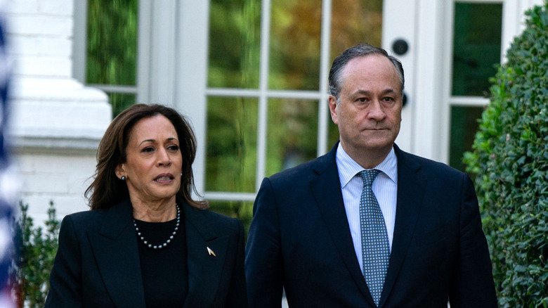 Kamala Harris and Doug Emhoff walking next to each other while wearing suits at Washington D.C.