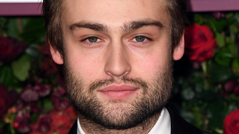 Douglas Booth posing at event