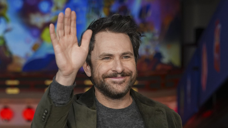 Charlie Day smiling and waving
