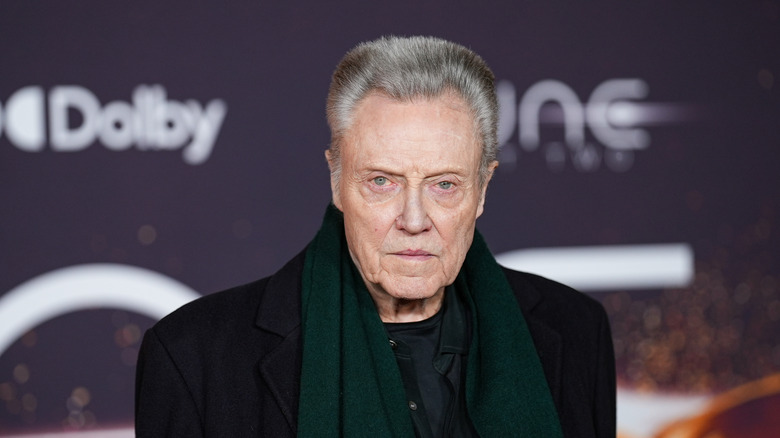 Christopher Walken in black formals and a green muffler