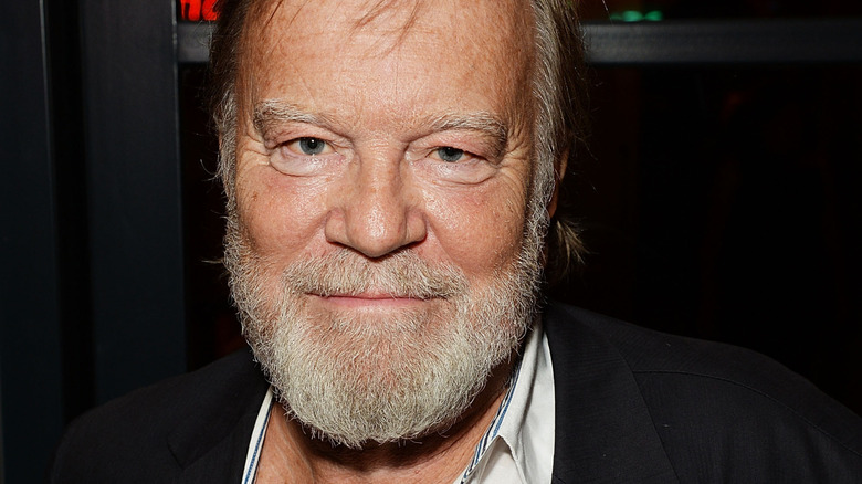 Nicky Henson smiling at event