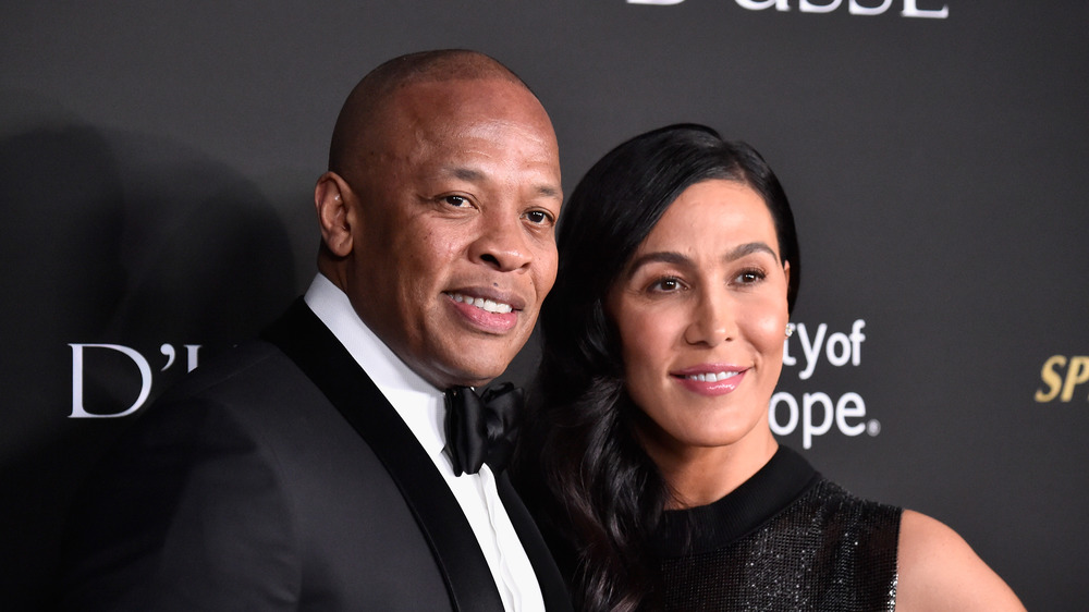 Dr. Dre and Nicole Young posing at a gala