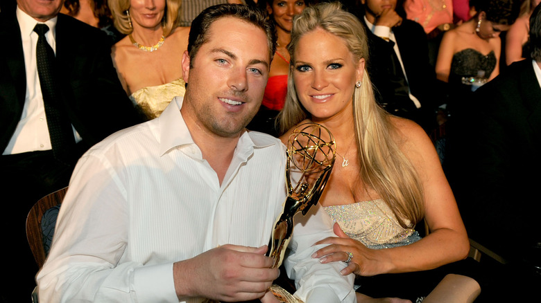 Dr. Phil's oldest son  Jay McGraw smiles sitting next to his wife as he holds an Emmy award in 2010