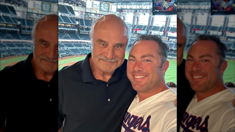 Dr. Phil and Jay McGraw posing in a selfie at a baseball game in 2023