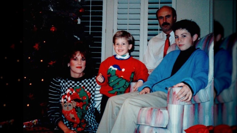 Robin McGraw and Dr. Phil with their sons in Christmas sweaters in the '90s
