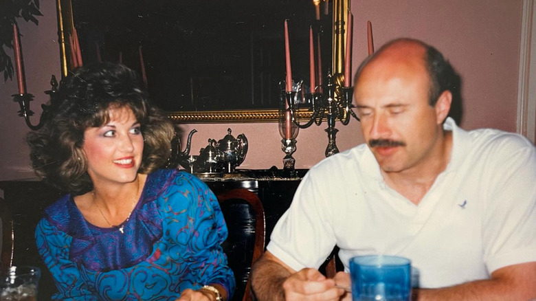 Dr. Phil McGraw and Robin McGraw sitting together at a table (est. the 1980s or '90s)