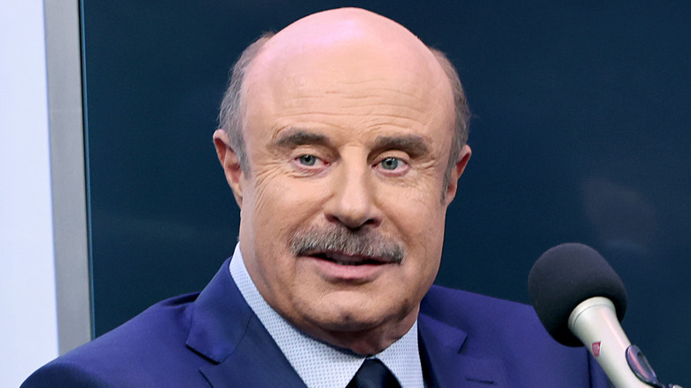 Dr. Phil McGraw speaking into a microphone