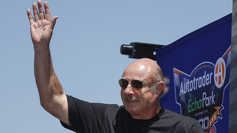 Dr. Phil McGraw waving to people at an event