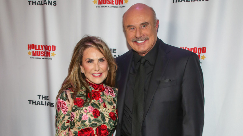 Robin McGraw flowered dress with Dr. Phil Hollywood Museum