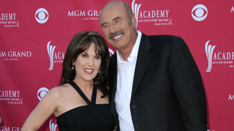 Robin McGraw and Phil McGraw smiling while posing together at an event