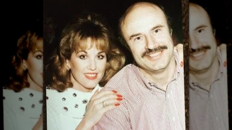 Robin McGraw and Dr. Phil embracing in their younger years.