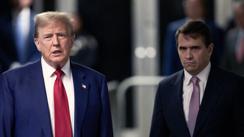 Donald Trump and Todd Blanche scowling