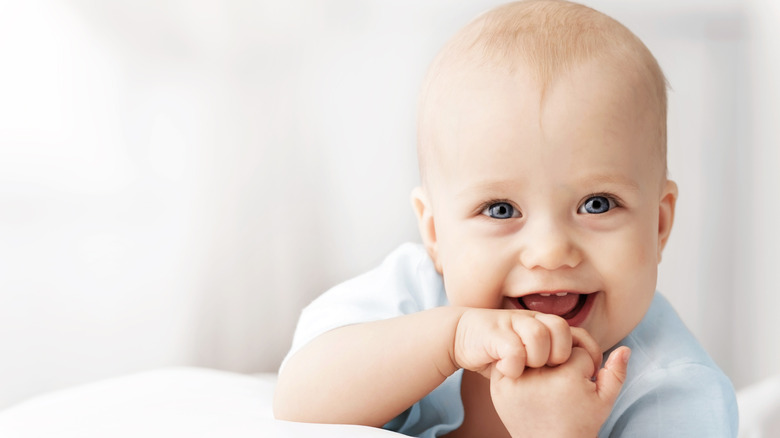Baby lying on their stomach and smiling