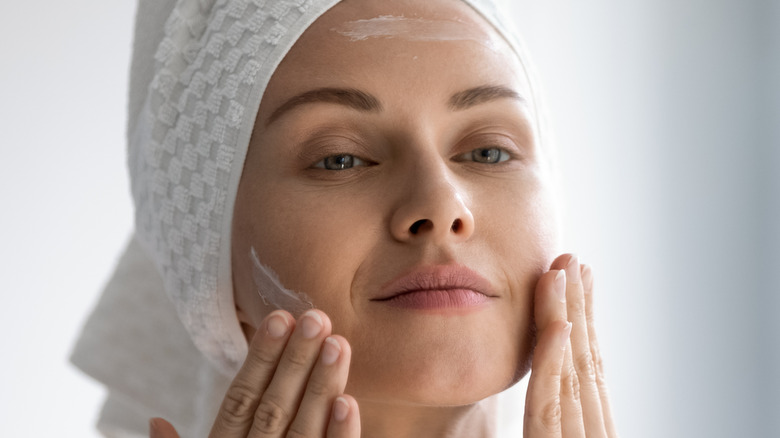 Woman dry cleansing her face