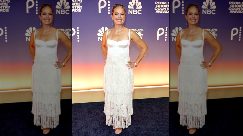 Dylan Dreyer poses in a white gown with a long fringe skirt.