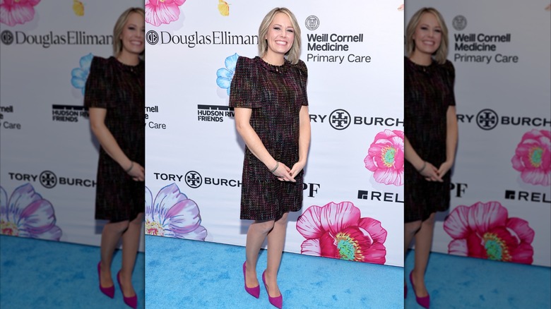 Dylan Dreyer in pink heels and a black dress with multicolored threads woven throughout.