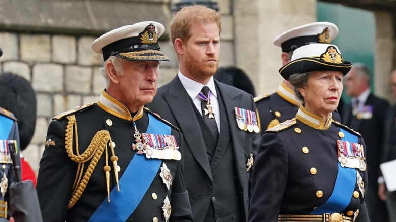 King Charles, Prince Harry, and Princess Anne walking