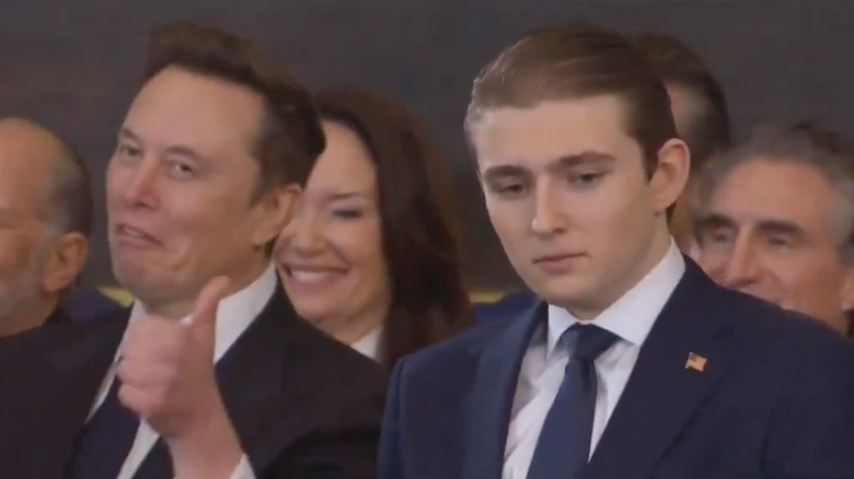 Elon Musk giving a thumbs up next to Barron Trump