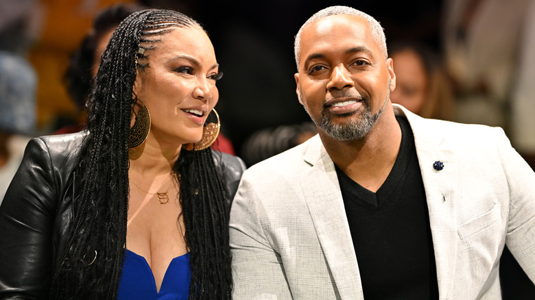 Egypt Sherrod looking at Mike Jackson as he smiles for the camera in a white blazer