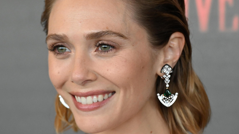 Elizabeth Olsen smiles on the Doctor Strange red carpet