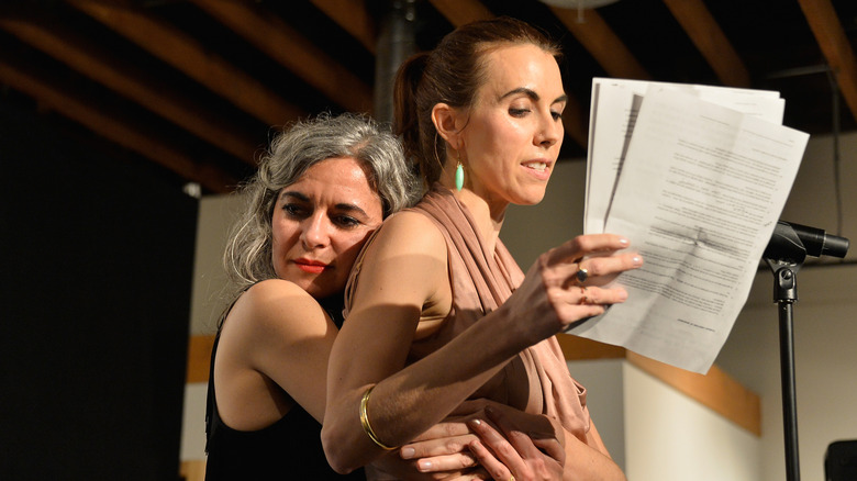 Laela Wilding hugs Naomi Wilding from behind