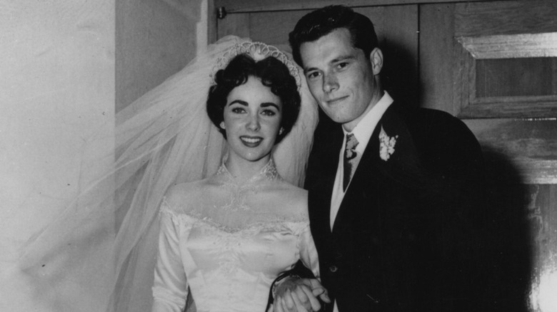 Conrad Hilton Jr. and Elizabeth Taylor smiling at their wedding