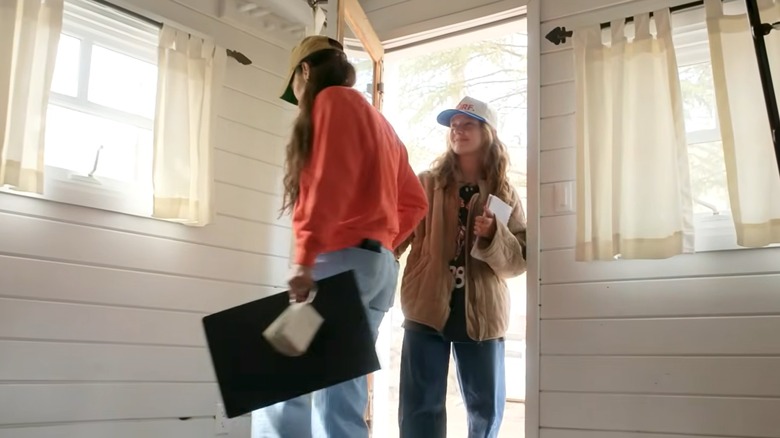 Joanna Gaines and Ella Gaines walking into a cottage on "Fixer Upper: Colorado Mountain House"
