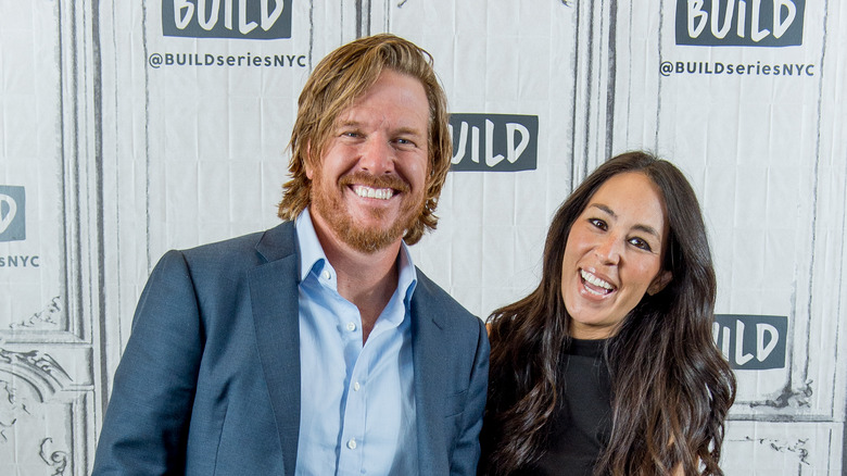 Chip and Joanna Gaines smiling while posing at an event together